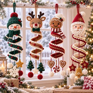 May include: Four hanging crochet Christmas ornaments featuring a snowman in a green hat, a reindeer, a gingerbread person, and Santa Claus. Each figure has a long, spiraling body decorated with small dangling charms like stars, trees, and hearts.