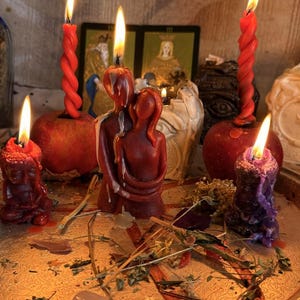 a collection of candles and figurines arranged on a tray, with a warm and inviting atmosphere.
