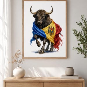 May include: A framed wall art print featuring a detailed illustration of a dark brown bull with large horns, draped in a vibrant blue, yellow, and red flag of Moldova. The artwork displays a watercolour style with visible paint splatters.