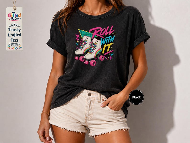 A woman wearing a black t-shirt with a graphic design of rollerblades and the text "Roll with it" printed on it.