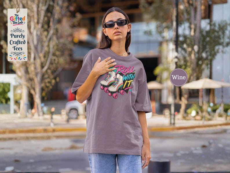 a t-shirt with a graphic design of rollerblades and the text "Roll with it",