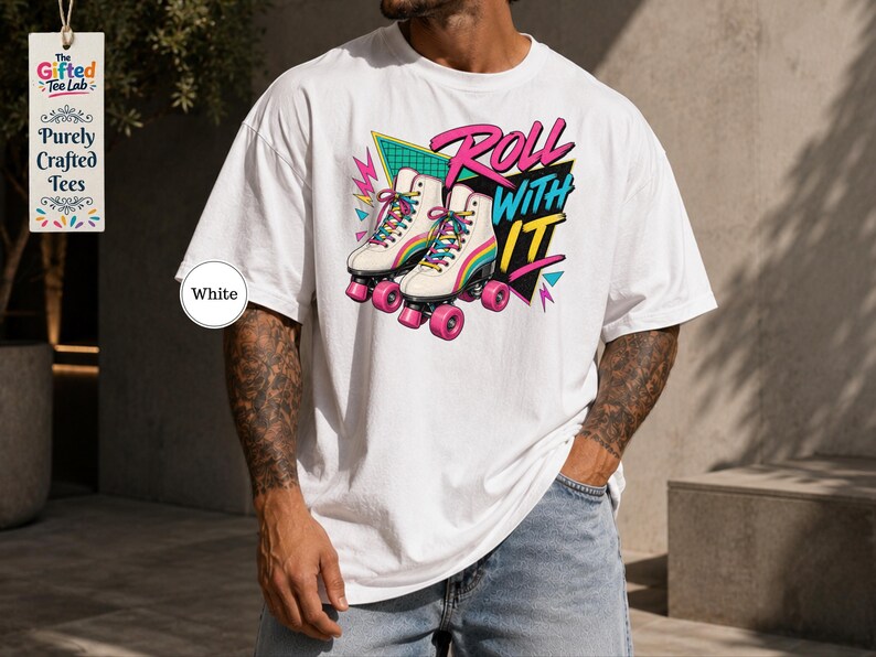A man wearing a white t-shirt with a graphic design of roller skates and the text "Roll with it" printed on it.