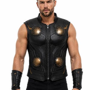 May include: A black sleeveless vest featuring a central zipper closure, structured paneling, and four prominent circular metallic bronze-toned discs on the chest and waist. The garment is paired with matching black leather wrist gauntlets.