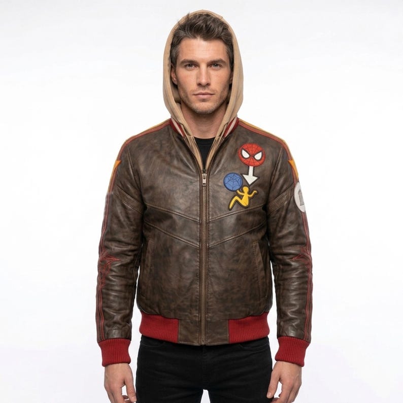 A man model wearing Marvel Rivals Inspired Spider-Man Bomber Leather Jacket with Hoodie, featuring embroidered Spider-Man inspired patches on the chest.