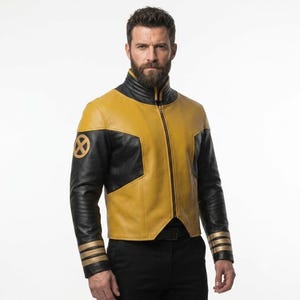 May include: A leather jacket featuring a mustard yellow and black color block design with a high collar and a full-length front zipper. The right sleeve displays a circular gold X-Men logo patch, while the cuffs are accented with three gold stripes.