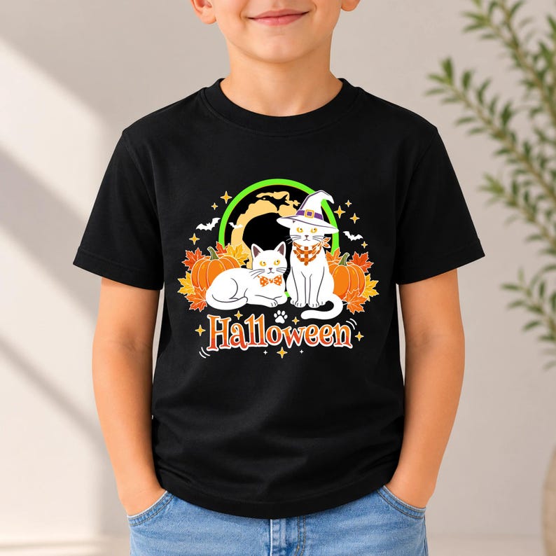 A graphic design featuring two black cats, one wearing a purple witch hat and orange bandana, sitting among pumpkins and autumn leaves under a full moon with the word Halloween below.