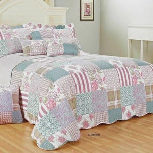 May include: A patchwork quilt and matching pillow sham set featuring a repeating pattern of floral prints, stripes, and geometric textures in shades of dusty rose, sage green, and cream. The quilt has a scalloped edge and the word BLOSSOM.