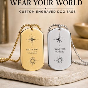 Könnte beinhalten: Zwei Erkennungsmarken an Kugelkettchen, eine goldfarbene und eine silberfarbene. Jede Marke zeigt ein Kompassrosen-Design und den Text: WEAR YOUR WORLD, CUSTOM ENGRAVED DOG TAGS, FRONT SIDE: (e.g., NAME, DATE, or Short Quote), Shop Now at GloMaxx.