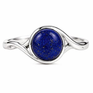 May include: A silver ring featuring a round, polished lapis lazuli gemstone as the centerpiece. The deep blue stone displays natural gold-colored pyrite flecks throughout its surface. The band has a smooth, polished finish and a bypass design.