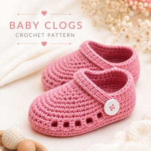 May include: A pair of pink crocheted baby clogs featuring a rounded toe, a strap with a white button, and small ventilation holes along the sides. The text BABY CLOGS CROCHET PATTERN is displayed above the shoes in a soft pink font with hearts.