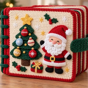 May include: A square, cream-colored crochet book with a red border and green spine rings. The cover features a green Christmas tree with colorful ornaments, a yellow star, a smiling Santa Claus, a small gift box, and holly leaves with red berries.