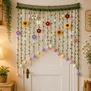 May include: A handmade crochet wall hanging featuring a dark green lattice top border with hanging vertical strands. The strands are decorated with various colorful crocheted flowers, including sunflowers, and white butterflies in different sizes.