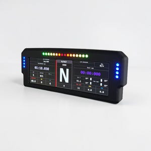 May include: A black digital dashboard with multiple data displays and LED lights. The screen shows lap times, speed, and other performance metrics. The device has blue LED lights on the sides and a row of multi-colored lights across the top.