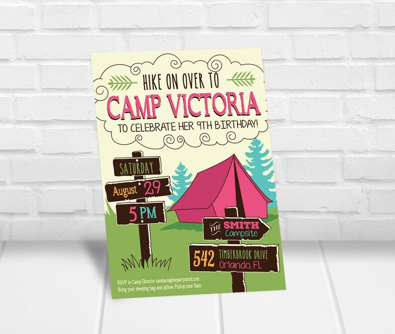 May include: A colorful invitation to a 9th birthday party at Camp Victoria. The invitation features a cartoon illustration of a campsite with a tent, trees, and a wooden signpost with the text "Saturday, August 29, 5 PM". The text "HIKE ON OVER TO CAMP VICTORIA TO CELEBRATE HER 9TH BIRTHDAY!" is written in a pink cloud shape. The text "THE SMITH CAMPSITE 542 TIMBERBROOK DRIVE ORLANDO, FL" is written on a brown sign with an arrow pointing to the right. The text "RSVP to Camp Director candacegthepartystark.com Bring your sleeping bag and pillow Pickup time 1am" is written at the bottom of the invitation.