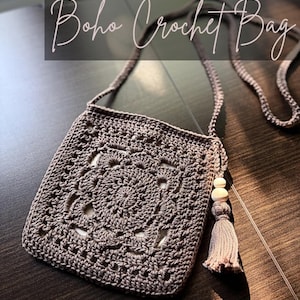 May include: A taupe crochet bag featuring a square granny pattern with a long shoulder strap. The bag is adorned with a decorative tassel and two light-coloured wooden beads. The text "Boho Crochet Bag" and "Willow Granny Square" is visible.