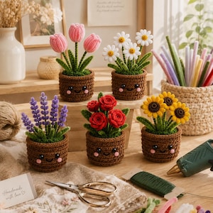 May include: Five crocheted potted plants featuring pink tulips, white daisies, purple lavender, red roses, and yellow sunflowers. Each brown pot has a stitched smiling face with pink cheeks. Crafting supplies including scissors and pipe cleaners are nearby.