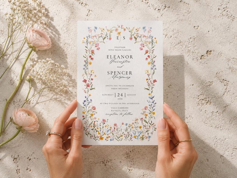 Bride holding editable wildflower wedding invitation printed on premium textured cardstock, showing realistic size, paper texture and floral artwork.