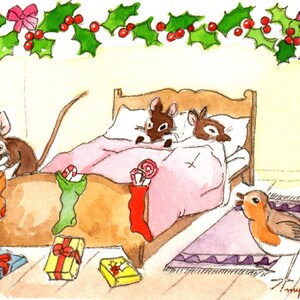 May include: A watercolour illustration of a Christmas scene with two mice sleeping in a bed under a garland of holly. A third mouse is peeking into a stocking hanging on the bedpost. A robin is perched on a rug near the bed. There are wrapped presents on the floor.