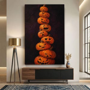 May include: A vertical wall art print featuring a stack of eight orange carved pumpkins with various facial expressions, including wide grins, heart-shaped eyes, and open mouths, set against a dark, textured, deep purple and black background.