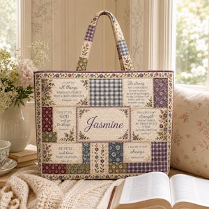 May include: A quilted tote bag featuring a patchwork design with floral patterns, blue gingham, and purple plaid. The bag displays the name Jasmine in the center, surrounded by various religious quotes and scripture verses printed on fabric panels.