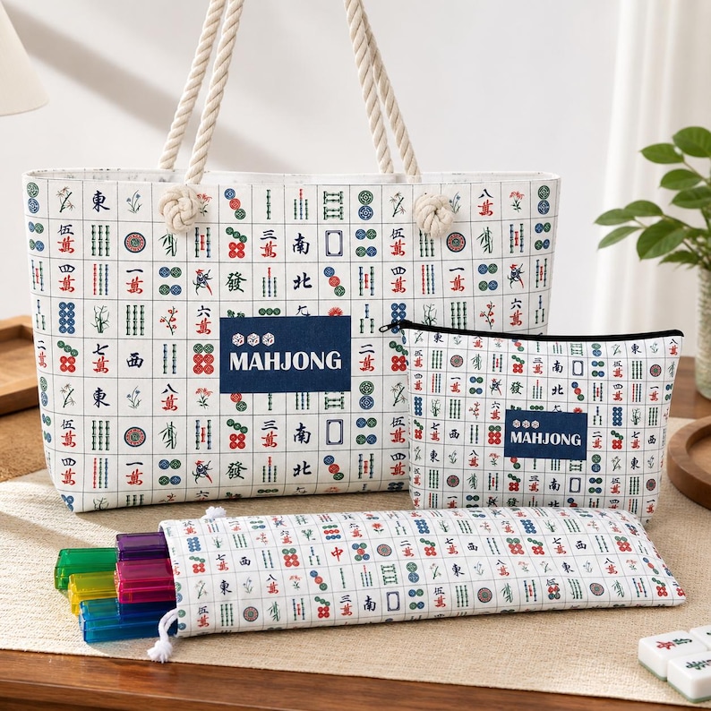 May include: A white tote bag, a zippered pouch, and a long rectangular case, all featuring a repeating grid pattern of colorful mahjong tiles. Each item includes a dark blue rectangular patch with the white text MAHJONG printed on it.