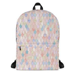 May include: A pink backpack with a mermaid scale pattern in shades of pink, blue, and green. The scales have a shimmery, iridescent finish.