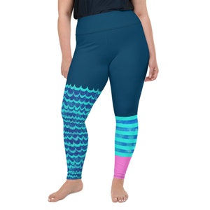 May include: Blue leggings with a mermaid tail design on one leg and blue and pink stripes on the other leg.