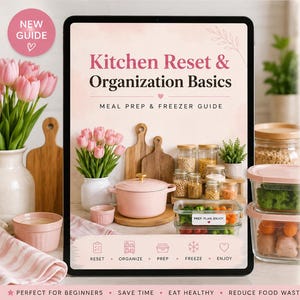 May include: A digital guide titled "Kitchen Reset & Organisation Basics" with meal prep and freezer tips. The image features a pink Dutch oven, food storage containers, and fresh tulips. Text includes "Reset, Organise, Prep, Freeze, Enjoy."