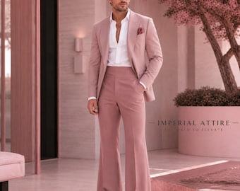 May include: A dusty rose suit featuring a single-breasted blazer with a notched lapel and a pocket square, paired with high-waisted flared trousers. A crisp white button-down shirt is worn underneath. The text Imperial Attire is visible.