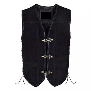 May include: A black suede vest featuring a braided leather trim along the edges, three antique brass-toned metal hook-and-eye closures down the front, and side lacing details with thin leather cords. The vest has a V-neckline and two pockets.