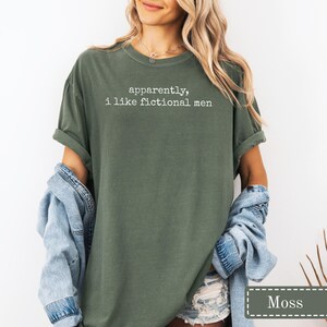 Green t-shirt with white text: "apparently, i like fictional men".