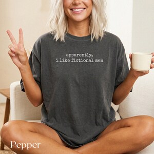 Dark grey t-shirt with white text "apparently, i like fictional men".