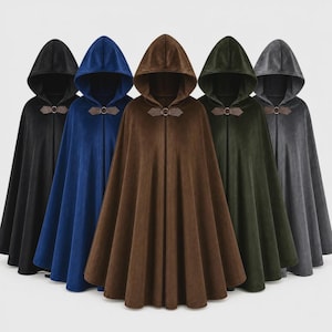 May include: Five hooded cloaks in black, blue, brown, dark green, and gray. Each cloak features a smooth, solid-colored fabric, a pointed hood, and a decorative metal clasp at the neck that secures the front opening of the garment.