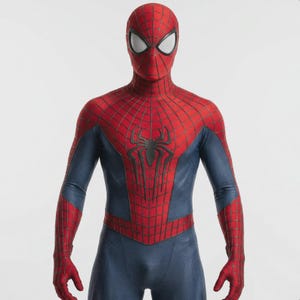 May include: A full-body Spider-Man costume featuring a red and blue color scheme. The costume has a red mask with white eye lenses, a red torso with a black spider emblem, and blue arms and legs. The suit is designed with a web-like pattern.