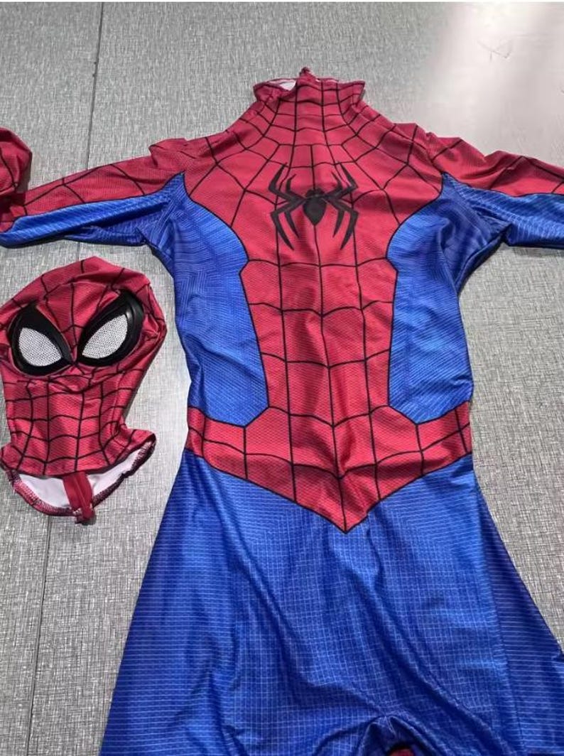 May include: A red and blue Spider-Man costume with a matching mask. The costume features a web pattern on the red areas and a black spider emblem on the chest. The mask has white eye coverings.