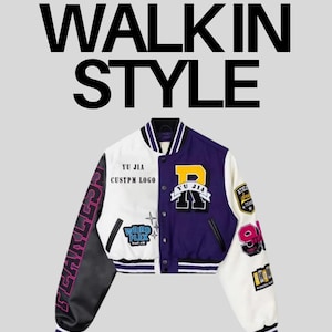 May include: A varsity jacket featuring a color-blocked design in purple, white, and black. The front displays patches with the text YU JIA CUSTPM LOGO and WEIRD FLEX but ok. The sleeves have patches including the word FEARLESS and the number 99.