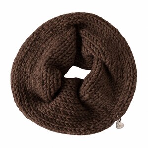 May include: A dark brown infinity scarf featuring a chunky knit texture with a circular loop design. A small, silver-toned heart-shaped metal charm is attached to the lower edge of the scarf, adding a subtle metallic detail to the dark brown yarn.