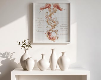 May include: A square wall art print featuring a grid background with a central illustration of a DNA strand intertwined with floral vines and a fetus at the base. Text reads: You knit me together in my mother's womb Psalm 139:13 and Before I formed you in the womb I knew you Jeremiah 1:5.