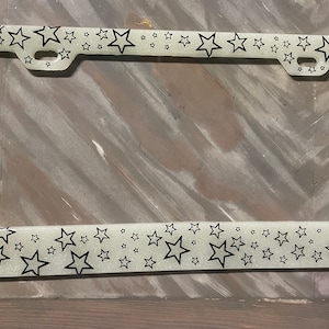 Glow in the dark glitter resin license plate with stars.