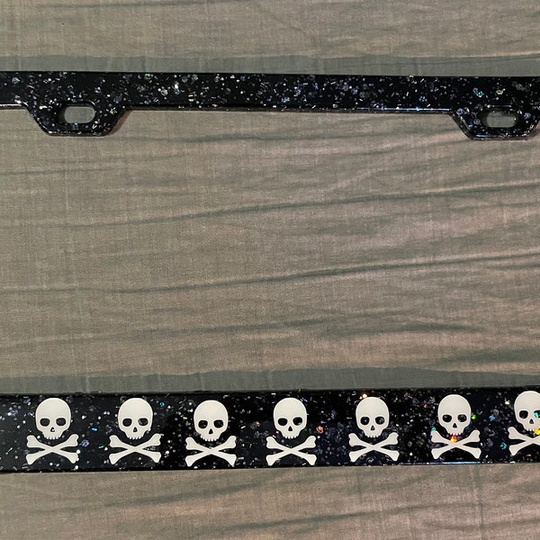 Black and silver glitter license plate frame with skulls