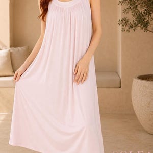 May include: A light pink, sleeveless nightgown with a round neckline and gathered detailing. The knee-length dress is made of a soft, flowing fabric. The word "SOLEA" is printed in a serif font at the bottom of the image.