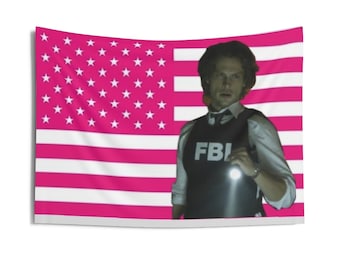 May include: A rectangular wall tapestry featuring a pink and white American flag pattern. Overlaid on the right side is a person with dark hair wearing a white collared shirt and a black tactical vest with the white text FBI printed on the chest.