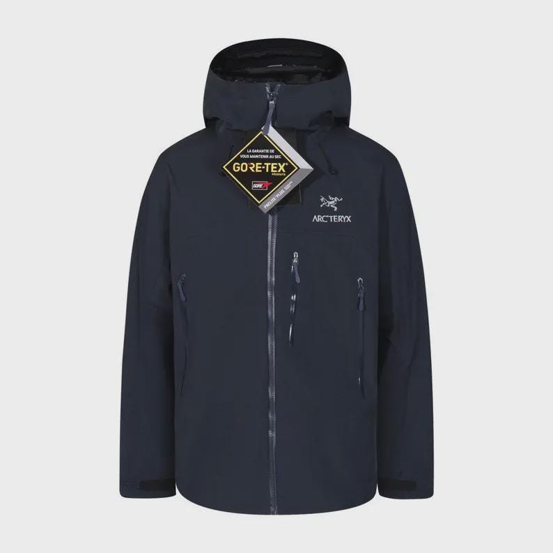 May include: A navy blue jacket with a hood, zip closure, and multiple pockets. The jacket displays the "GORE-TEX" logo and the "Arc'teryx" brand name. Designed for outdoor use, it offers protection from the weather.