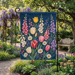 May include: A navy blue garden flag featuring a vibrant floral design. The flag showcases a variety of flowers, including tulips, daisies, and foxgloves, in shades of pink, yellow, white, and purple. The flag is designed for outdoor use.