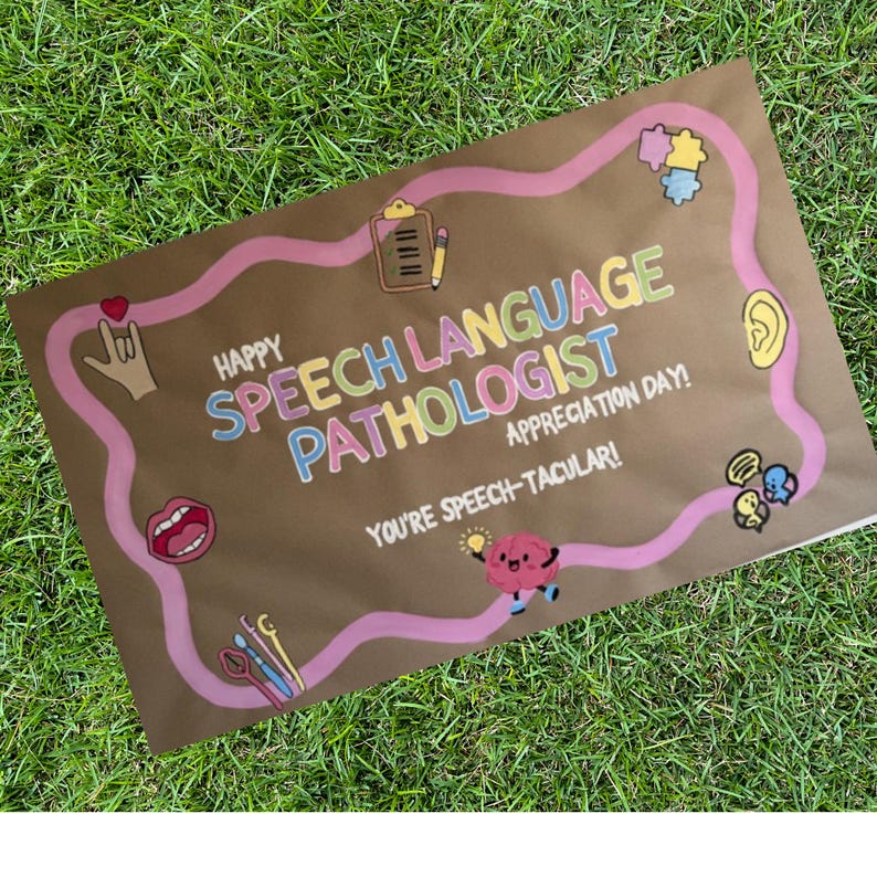 May include: A brown paper sign with the words "Happy Speech Language Pathologist Appreciation Day!" in colorful lettering. A pink wavy line surrounds the text and includes various illustrations, such as a brain, ear, and mouth.
