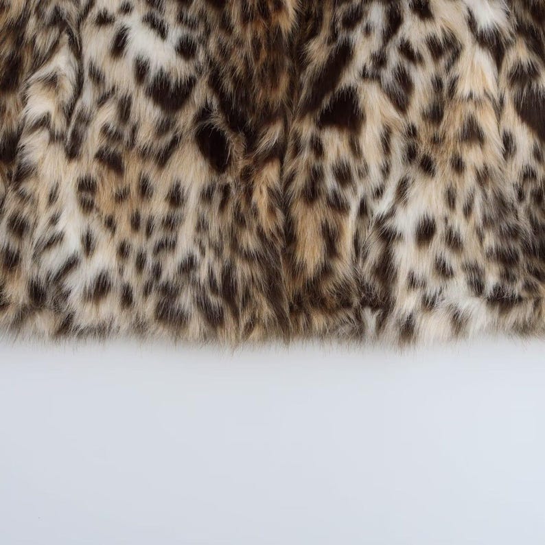 Women's leopard print polyester faux fur jacket with plush texture, wide collar, and long sleeves