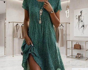 May include: A green, short-sleeved dress with a white polka dot pattern. The dress has a round neckline and falls to the mid-calf. The image shows the dress in a boutique setting, with clothing racks and a display.