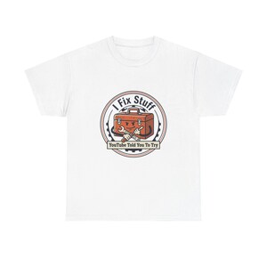 May include: White t-shirt featuring a circular graphic with a toolbox and crossed wrenches. The text "I Fix Stuff" arches above the toolbox, with "Youtube Told You To Try" below. The toolbox has a smiling face.