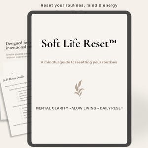 May include: A digital tablet showing "Soft Life Reset™", a guide to resetting routines. The image includes a checklist and the phrases "Mental Clarity, Slow Living, Daily Reset." The text "Reset your routines, mind & energy" is also visible.