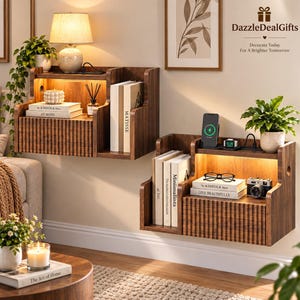 May include: Two dark wood floating nightstands with integrated LED lighting, fluted drawer fronts, and open shelving. Each unit holds books, a potted plant, and electronic charging accessories. Text DazzleDealGifts Decorate Today For A Brighter Tomorrow.